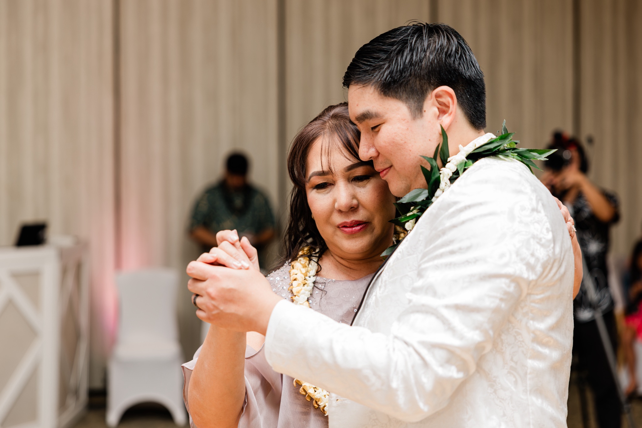 Newlyweds share a first dance at their Oahu wedding