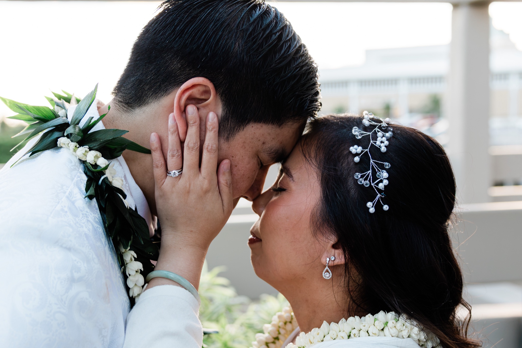 Intimate forehead-to-forehead moment, Oahu wedding