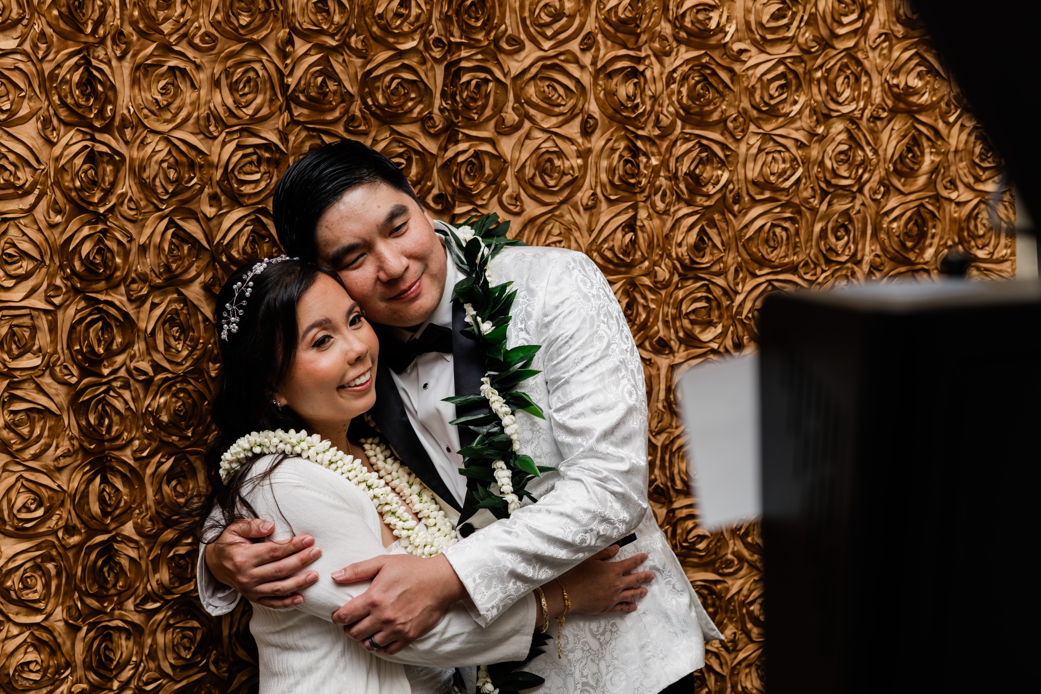 Mitchell and Alina embrace at their Oahu wedding reception