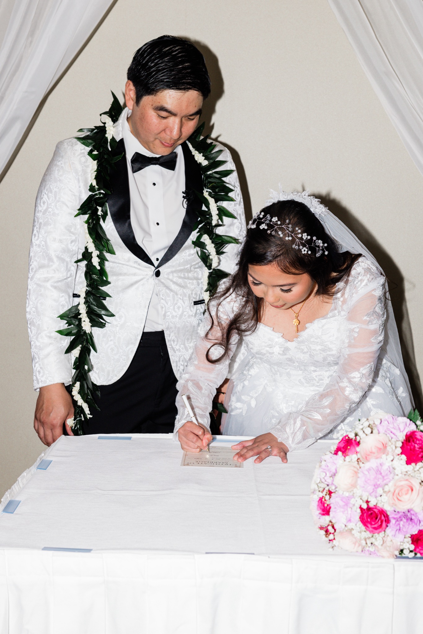 Signing the marriage certificate at an Oahu wedding